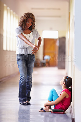 Buy stock photo Teacher, school and scolding child student for bad behaviour, problem or disobedience. Angry black woman pointing to punish scared girl for discipline, conflict or education fail in building hallway