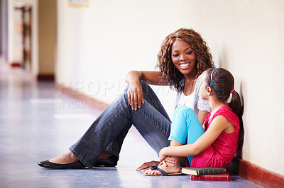 Buy stock photo Teacher, student and talking or conversation at school for support, trust or education. Happy black woman working at school for child discussion about bullying, learning and development in hallway