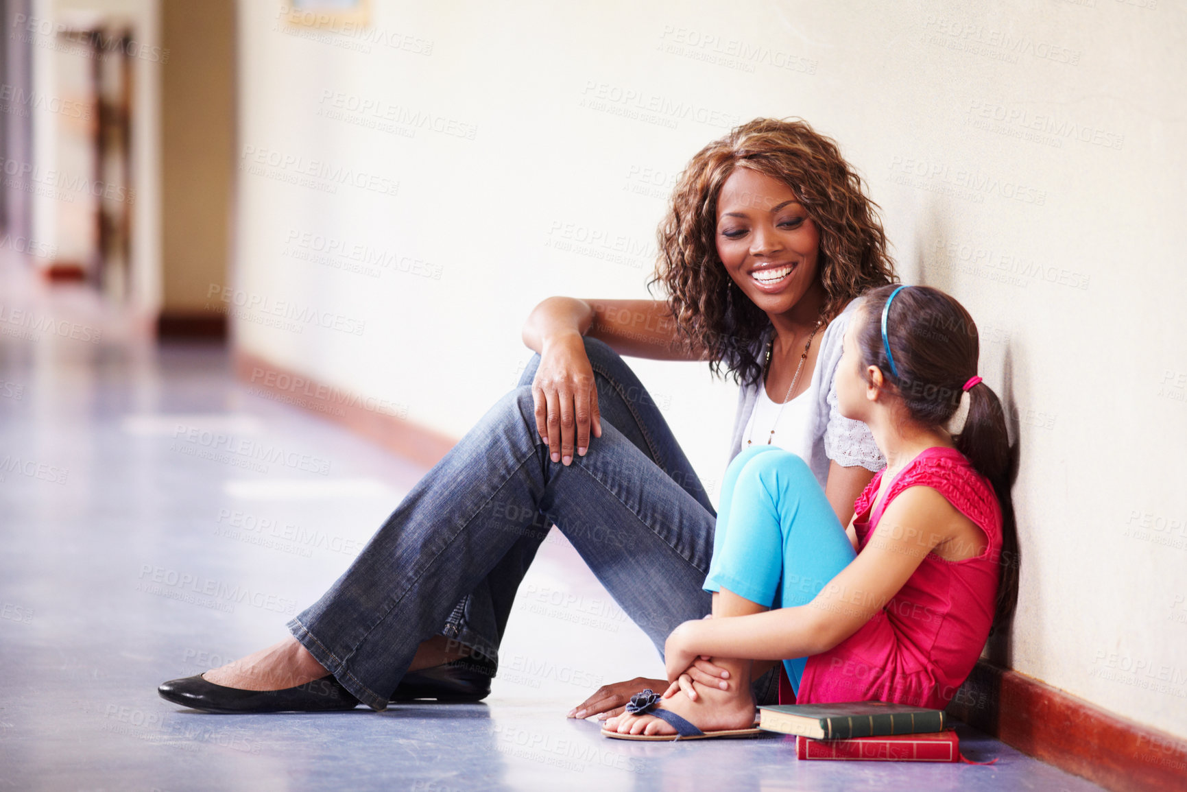 Buy stock photo Teacher, student and talking or conversation at school for support, trust or education. Happy black woman working at school for child discussion about bullying, learning and development in hallway