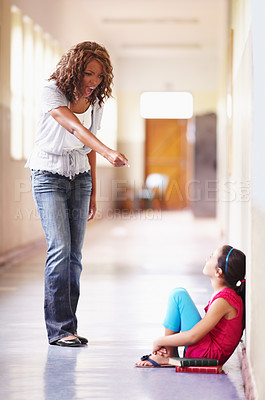 Buy stock photo School, teacher and shouting at child student for bad behaviour, problem or lesson. Angry black woman pointing and scolding girl for discipline, attitude or education fail in building hallway