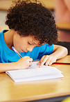 Writing in his homework book