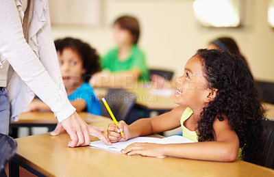 Buy stock photo Child, writing and hand of teacher teaching student at school for education, learning or development. Woman and happy girl with notebook, pencil and knowledge at classroom desk with support and smile