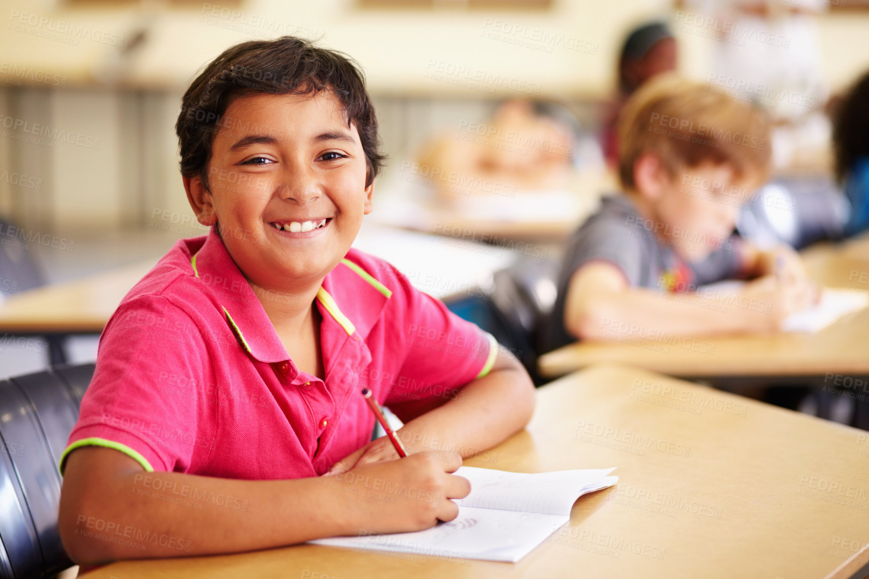 Buy stock photo Education, learning and portrait of kid in classroom, smile and writing in book at Montessori school. Happy face, students at desk in class and studying, child development and kids in study or test.