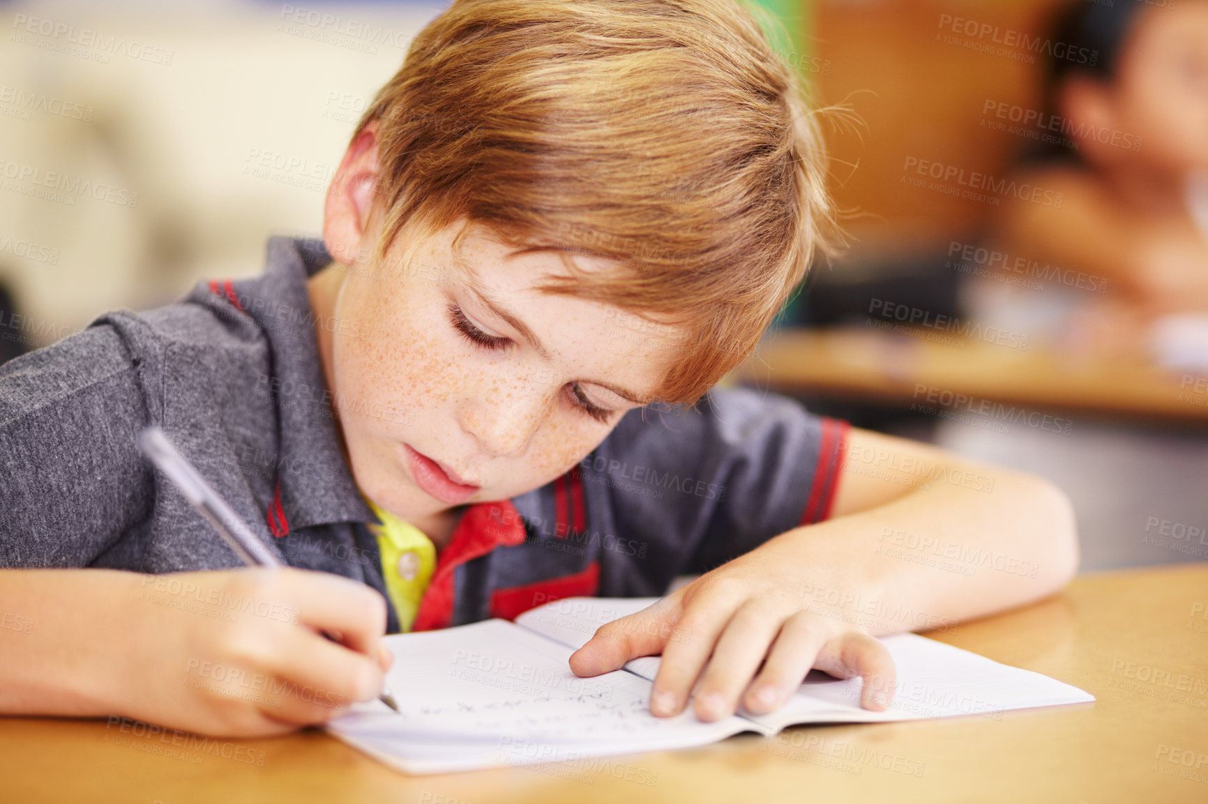 Buy stock photo Education, student and boy writing, focus and learning with creativity, book and reading. Male person, child and kid in school, classroom and knowledge with exam, future and test for development