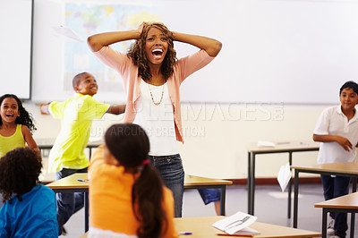 Buy stock photo Stress, teacher shouting and black woman in classroom with children running around. Education, headache and female person screaming with burnout, tired or fatigue with kids in busy class at school.