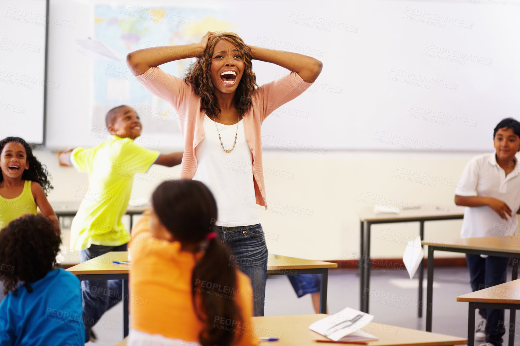 Buy stock photo Stress, teacher shouting and black woman in classroom with children running around. Education, headache and female person screaming with burnout, tired or fatigue with kids in busy class at school.