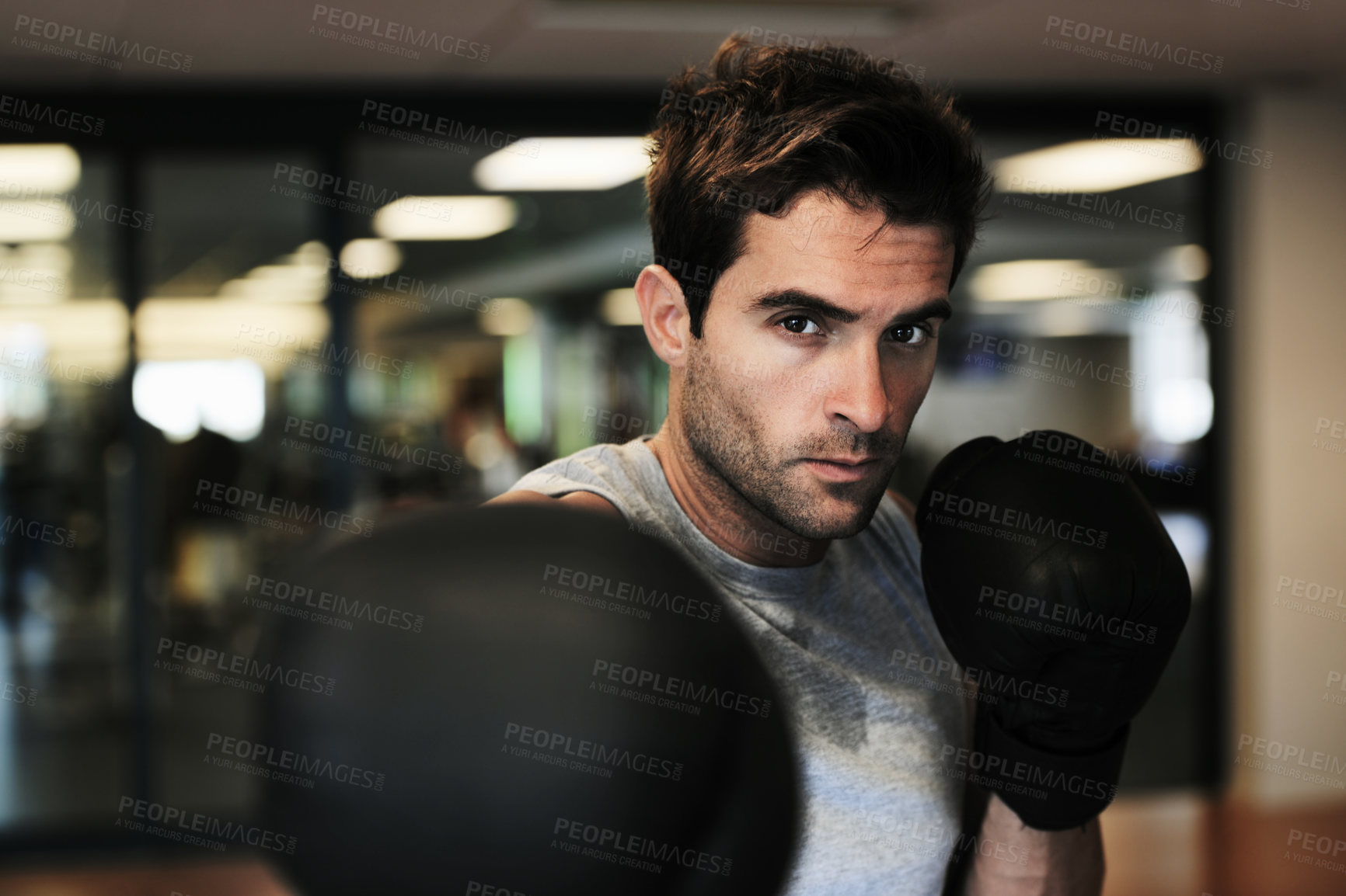 Buy stock photo Man, boxing gloves and punch with gym for fitness, wellness or training for fight, performance or sport. MMA, boxer or strong for contest, competition or exercise for development, sweat and workout