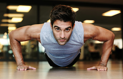 Buy stock photo Portrait, man and fitness with push up in gym for exercise in strength, health or wellness. Male person, alone and training on floor with workout routine for endurance, concentration and dedication