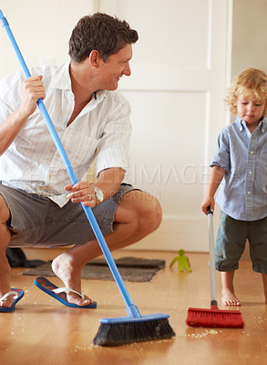 Buy stock photo Man is cleaning with boy child, sweeping with broom and help with mess on floor while at home together. Hygiene, chores and house work with man teaching kid to sweep and helping with crumbs on ground