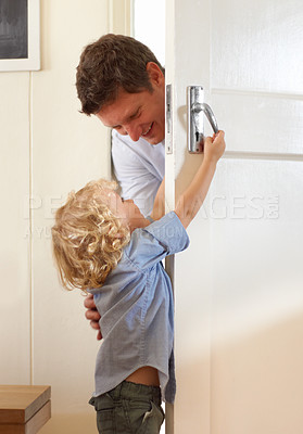 Buy stock photo Boy, playing and open door for father with game, surprise or bonding with happiness, love or care in family home. Man, male child and playful in home with childhood development, excited and support