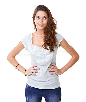 Buy stock photo A gorgeous young woman standing with her hands on her hips while looking sideways