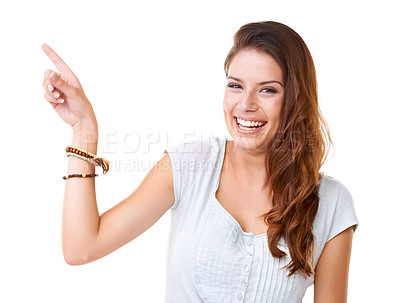 Buy stock photo Portrait of a smiling young woman pointing at copyspace