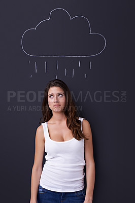 Buy stock photo Thinking, sad and rain cloud with woman on a chalkboard for drawing, emotion or expression in studio. Depression, idea or weather and an unhappy young person with a chalk picture of a winter storm