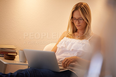 Buy stock photo Woman, laptop and journalist in relax on chair typing, reading or writing in living room at home. Calm female person, freelancer or typist in remote work on computer for online connection at house