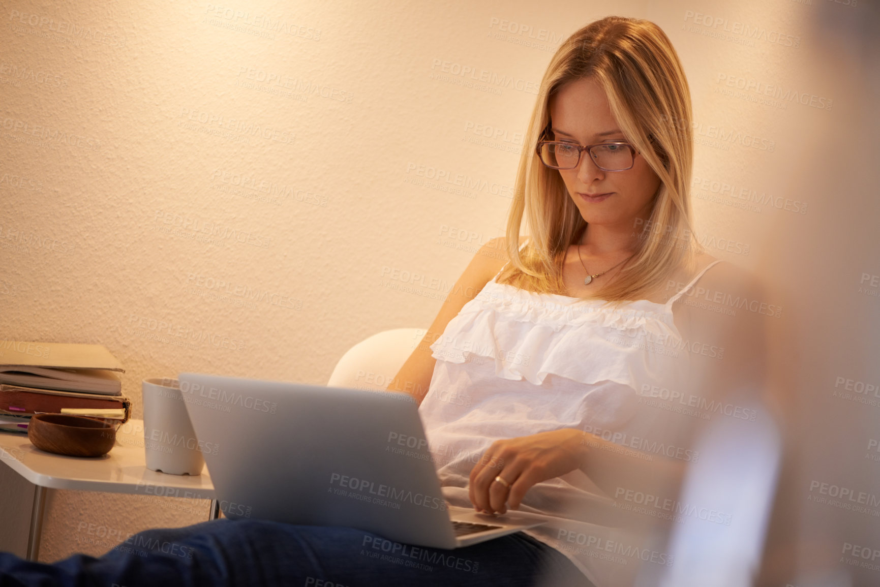 Buy stock photo Woman, laptop and journalist in relax on chair typing, reading or writing in living room at home. Calm female person, freelancer or typist in remote work on computer for online connection at house