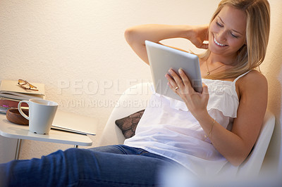 Buy stock photo Happy woman, tablet and relax on chair for social media, streaming or entertainment in living room at home. Female person smile with technology for online search, communication or networking at house