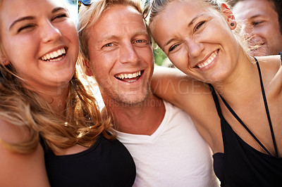Buy stock photo A group of smiling friends enjoying each others company