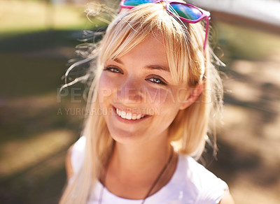 Buy stock photo Portrait of a beautiful young woman enjoying a sunny day outdoors