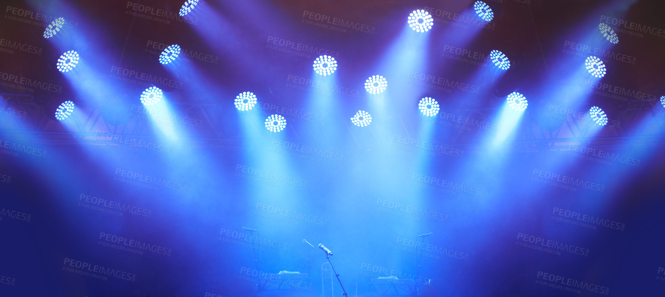 Buy stock photo A stage at a music festival with lights streaming down from above