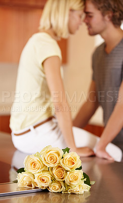 Buy stock photo Couple, flowers and hug in kitchen love for anniversary celebration, connection or romantic date bonding. Woman, man and partnership in home with roses for surprise bouquet, present for floral gift