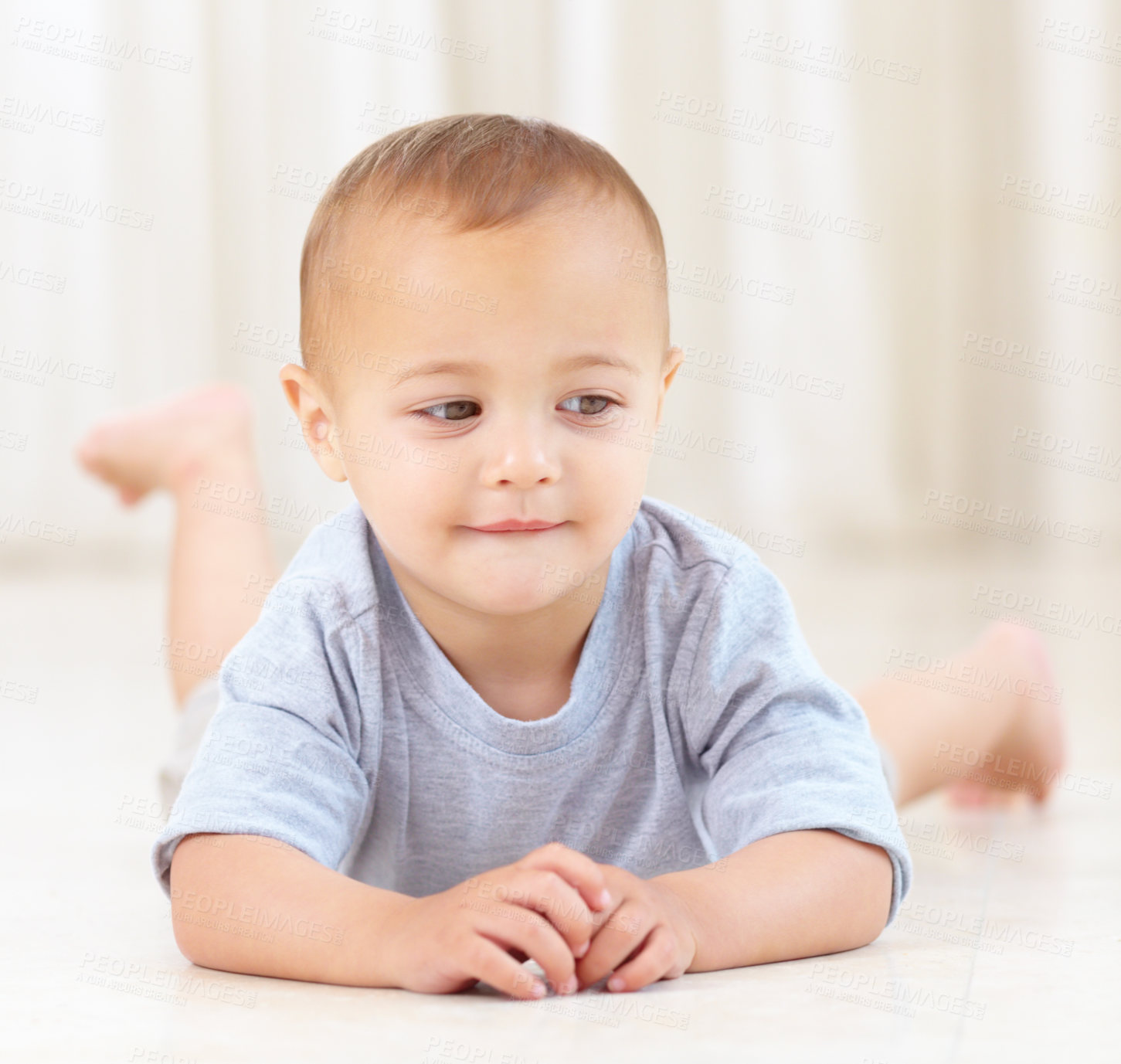 Buy stock photo Cute, smile and baby at his home playing for child development and growth. Sweet, youth and happy boy newborn, infant or kid having fun, relaxing and laying on the floor in a modern family house.