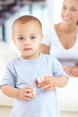 Buy stock photo Cute, building blocks and portrait of baby at his home playing for child development and growth. Sweet, youth and boy newborn, infant or kid having fun and standing with toys in a modern house. 