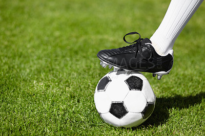 Buy stock photo Cropped shot of a female football players leg standing on a soccer ball