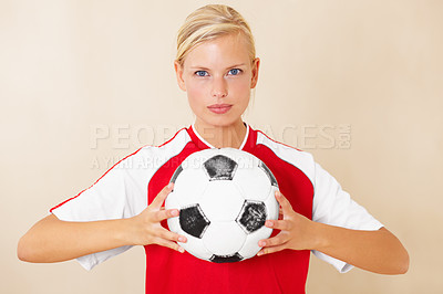 Buy stock photo Portrait of an attractive young woman holding a soccer ball