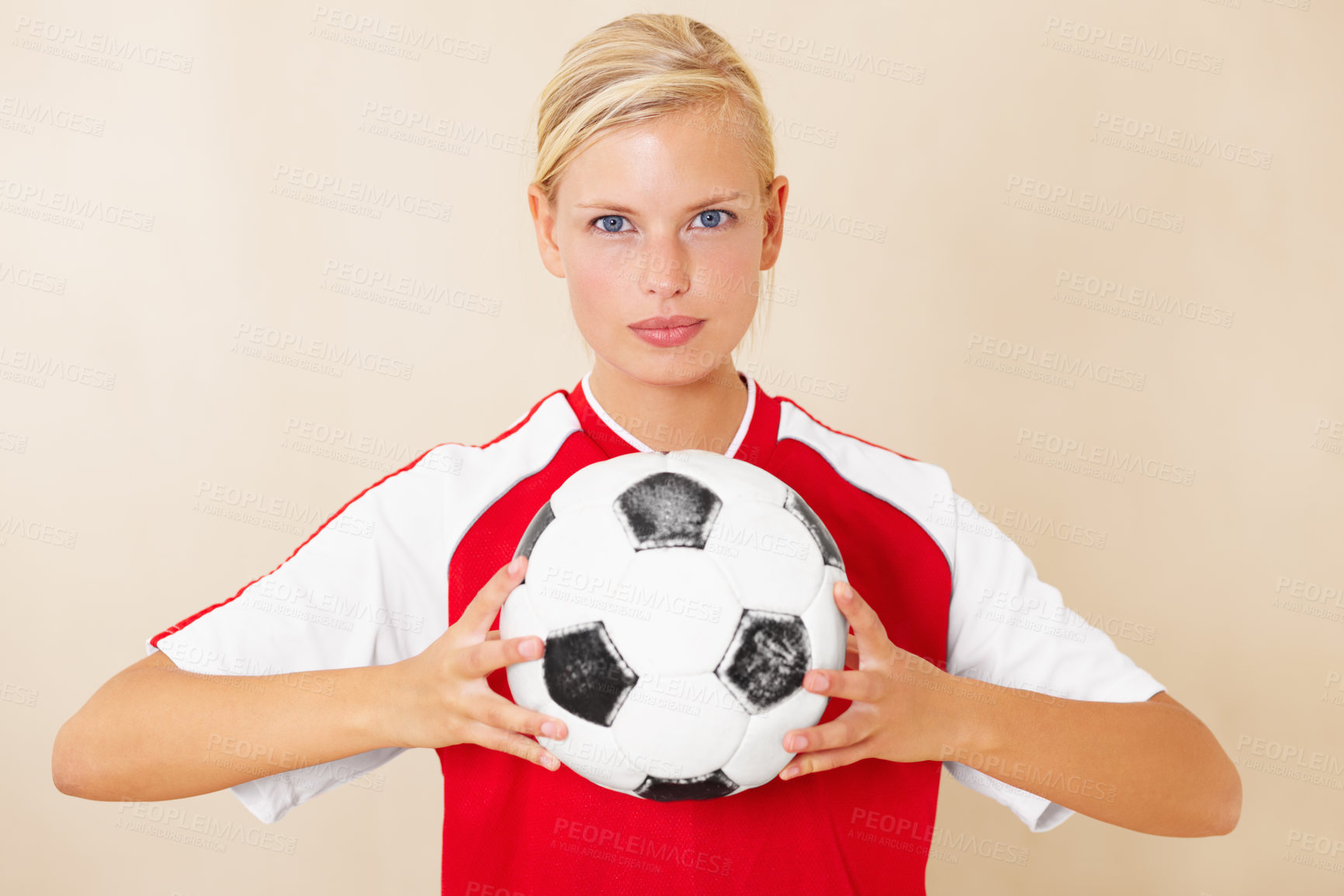 Buy stock photo Portrait of an attractive young woman holding a soccer ball