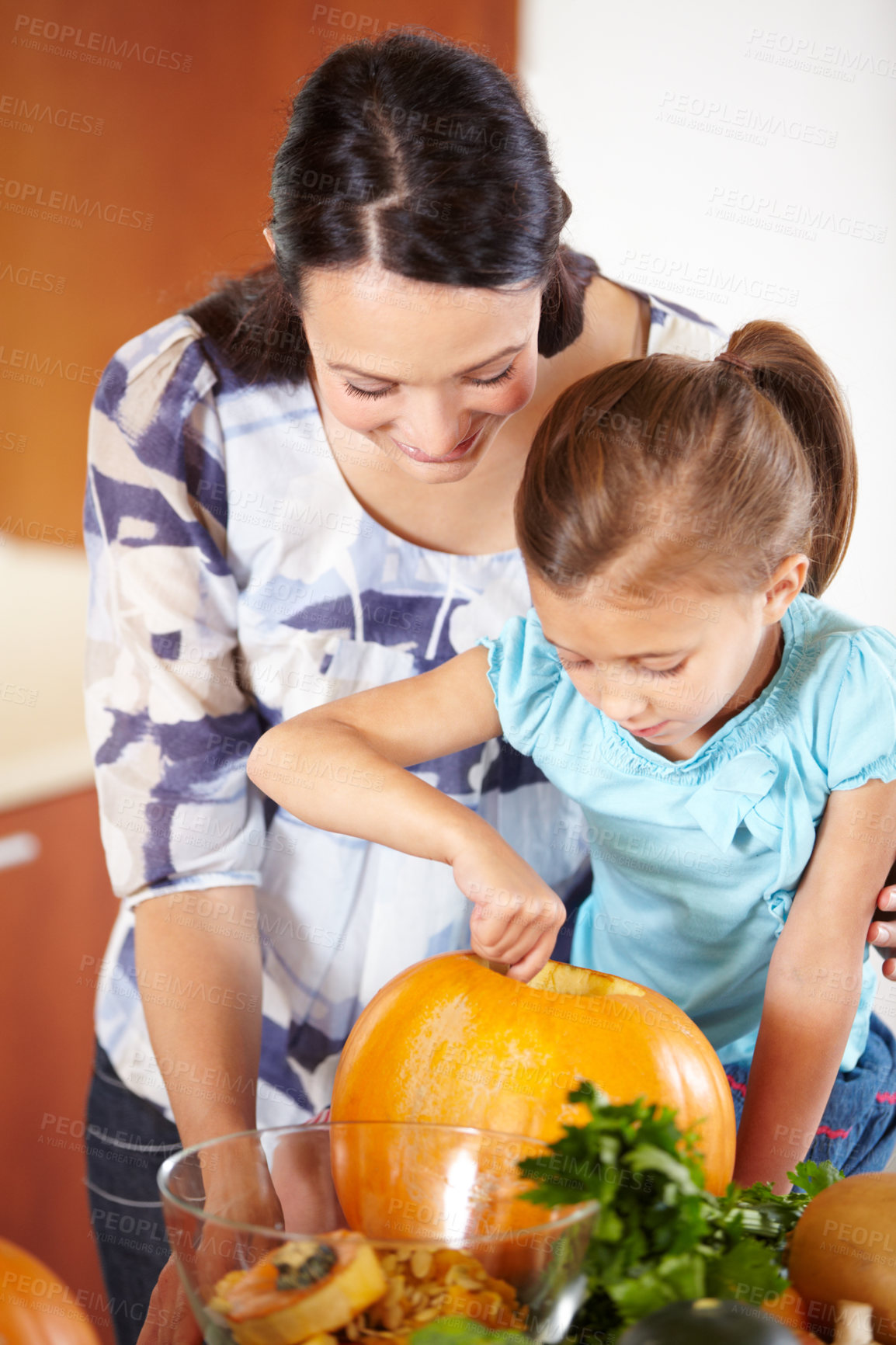 Buy stock photo Halloween, pumpkin and a woman in the kitchen with her daughter holiday celebration at home. Creative, smile or happy with a mother and girl child carving a vegetable for decoration or tradition