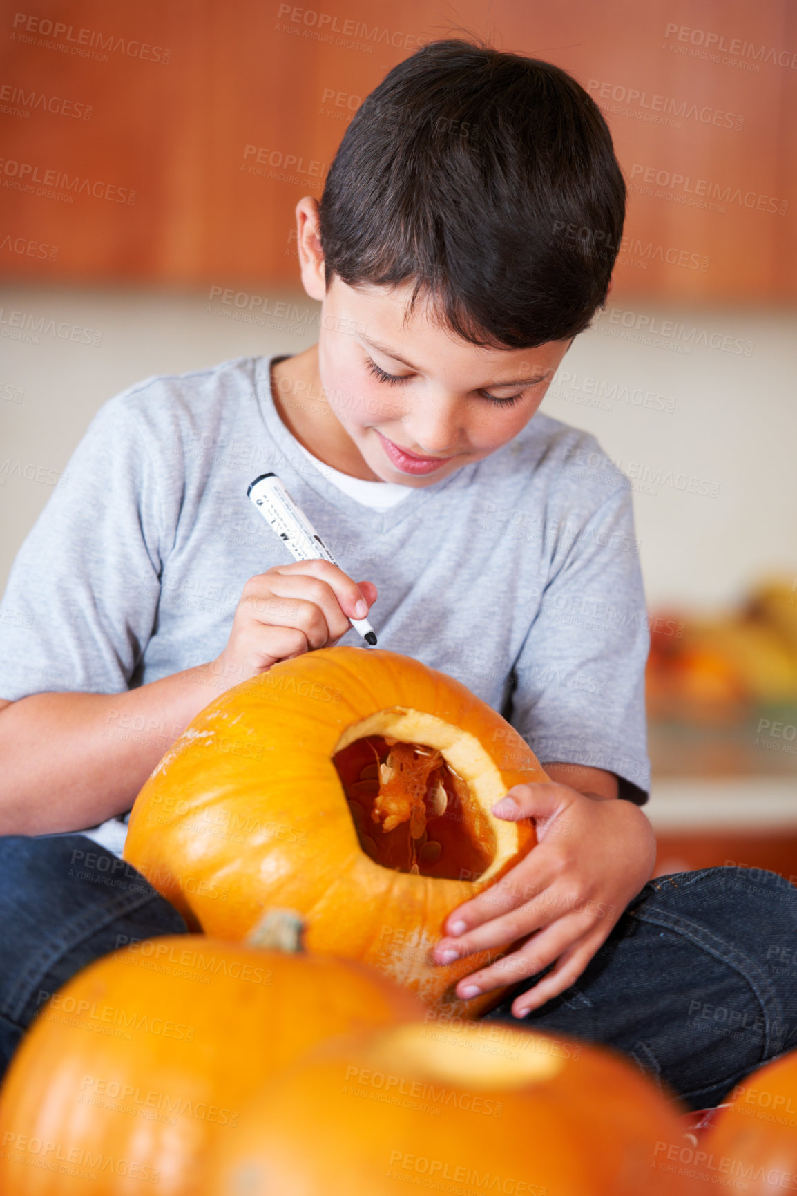 Buy stock photo Halloween, pumpkin and boy kid in the kitchen for holiday celebration at modern home. Creative, smile and happy young child and carving vegetable for fun, decoration or tradition at family house.
