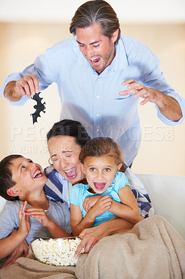 Buy stock photo A family playing a prank at halloween