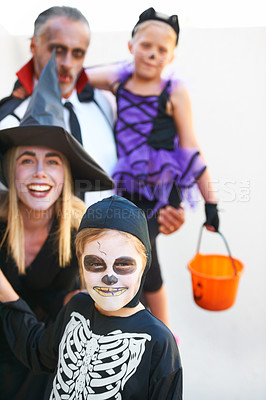 Buy stock photo Portrait, halloween and a family in costume for the tradition of trick or treat or holiday celebration. Mother, father and kids at a door in fantasy clothes for dress up on allhallows eve together