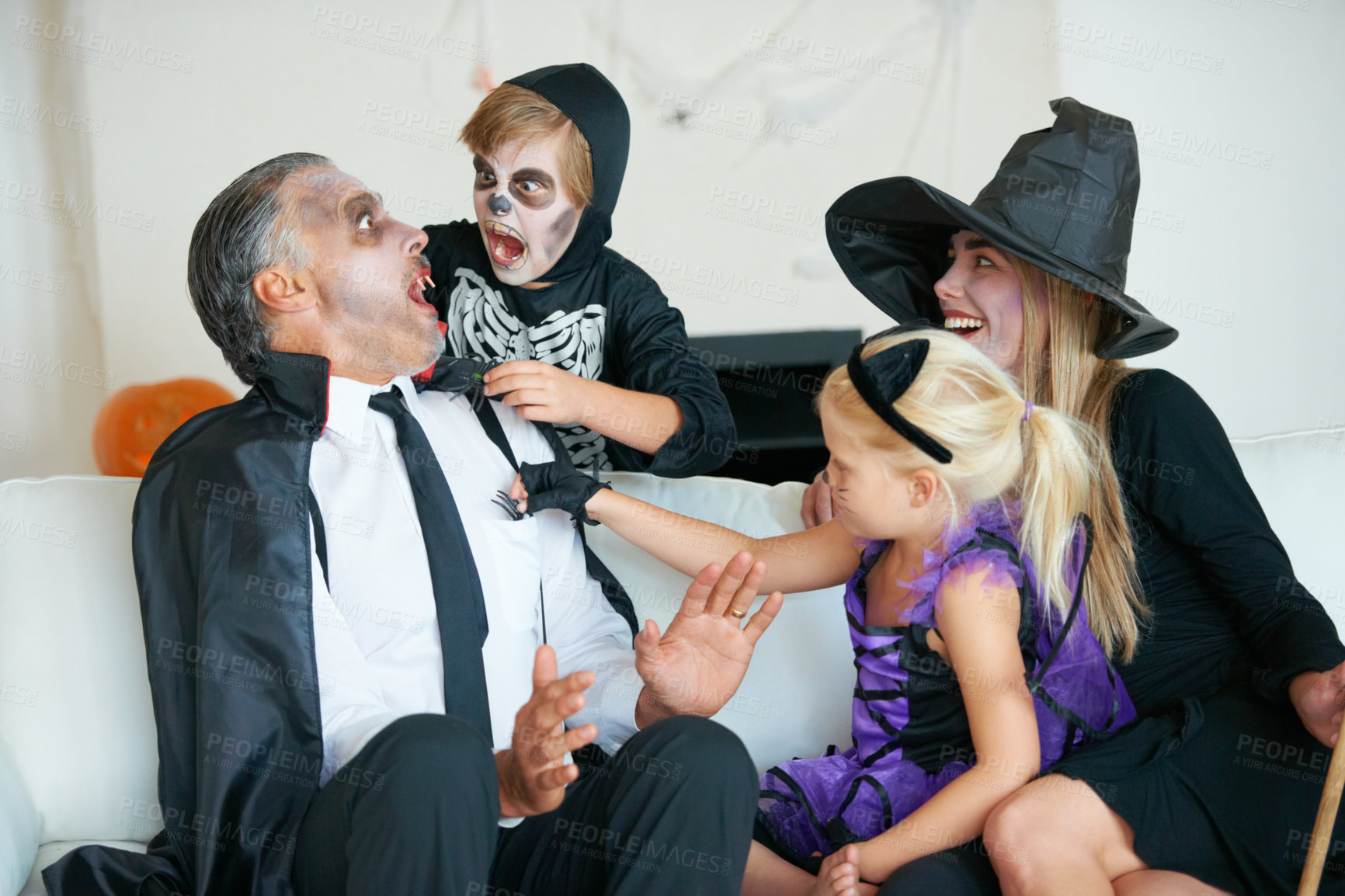 Buy stock photo A cute family dressed up for Hallowe'en all trying to scare each other