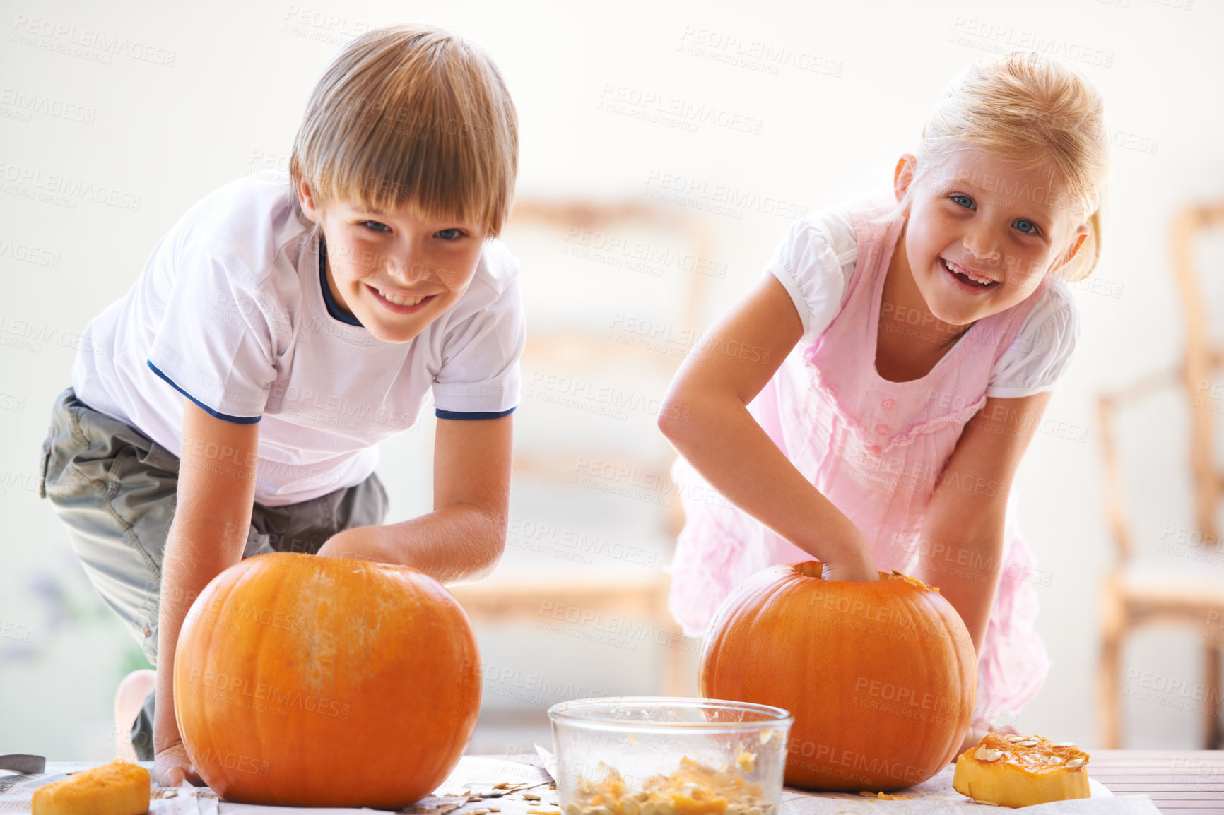 Buy stock photo Halloween, portrait and carving a pumpkin with children at a home table for fun and bonding. Boy and girl or young kids as siblings together for creativity, holiday lantern and happy craft and play