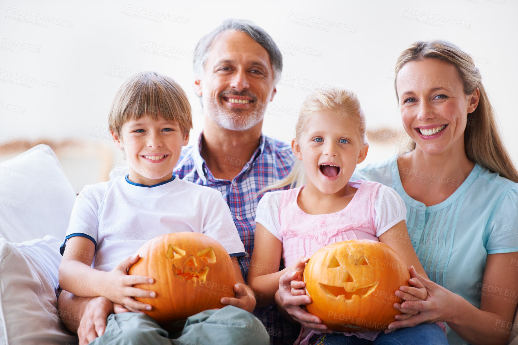 Buy stock photo Happy family, couch and halloween pumpkins for holiday decoration, childhood memories and joy. Parents, children and embrace together with excitement, celebration and carving vegetable for tradition