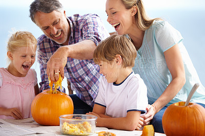 Buy stock photo Happy family, laughing and carving halloween pumpkins for holiday decoration, childhood memories and joyful. Parents, children and playful together with excitement, celebration and tradition