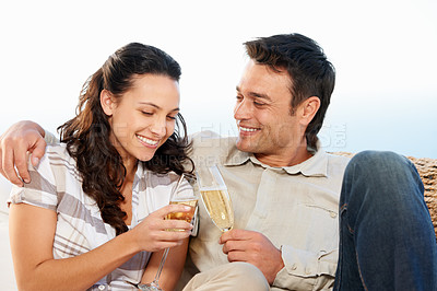Buy stock photo Couple, drinking champagne and toast for honeymoon and good news for celebration, announcement and love. Looking at wife, smile and happy with romantic gesture, bonding together and anniversary