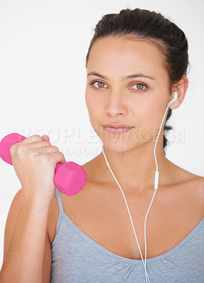 Buy stock photo Portrait, fitness with dumbell and a woman with headphones for music while exercising on a white studio background. Strong, arm and health with face of female athlete weightlifting for training