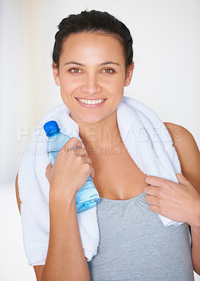 Buy stock photo Happy woman, portrait and fitness with water bottle for hydration or natural nutrition at gym. Face of female person smile with mineral drink and towel for exercise, workout or training in wellness