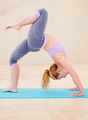 Buy stock photo Fitness, yoga and woman stretching body on mat for flexibility, wellness and balance in studio. Sports, healthy workout and female person in gym class for exercise training and pilates in wheel pose