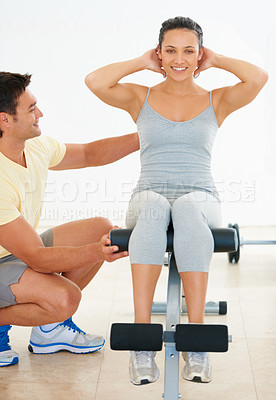 Buy stock photo Personal trainer, woman and gym machine for crunch and fitness workout. Instructor, coach and healthy people with exercise equipment for strong body and athletic training for active lifestyle