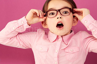 Buy stock photo Portrait, shocked and girl child with glasses in studio isolated on a pink background. Kid, nerd and face of surprised person, wow or omg, emoji or reaction to unexpected news, announcement or secret