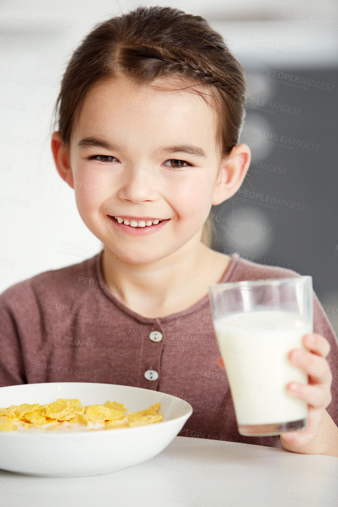 Buy stock photo Portrait of a cute little girl drinking a glass of milk with her cereal