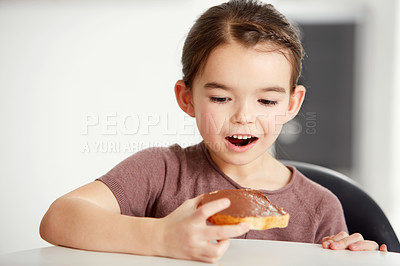 Buy stock photo Little girl, toast and chocolate spread for sweet, delicious or desert snack on bread in kitchen at home. Young female person, child or kid in surprise for food or candy treat on wheat at house