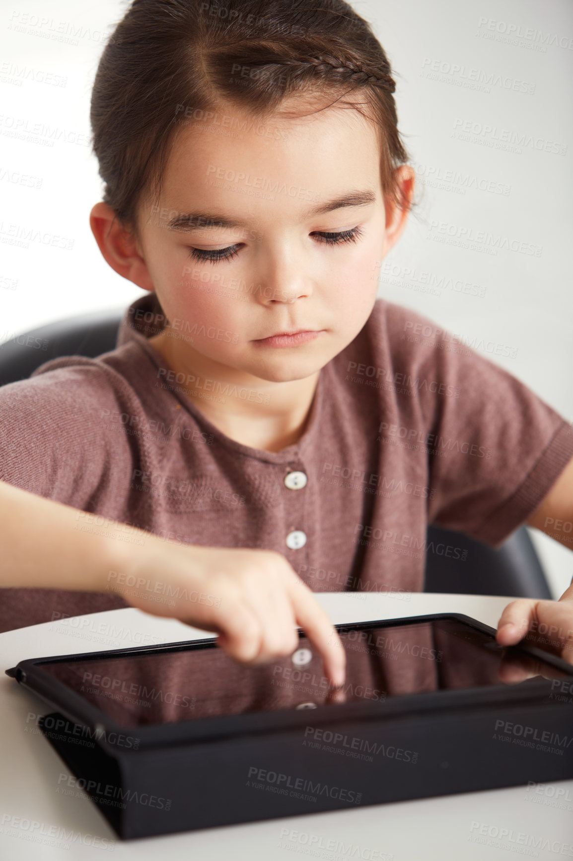 Buy stock photo Little girl, tablet and watching in living room for games, online entertainment or research at home. Face of young female person, child or kid with technology for communication or networking at house