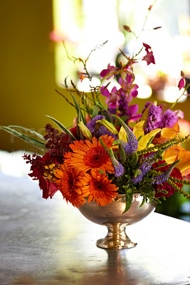 Buy stock photo Shot of a colourful arrangement of fresh flowers in a silver vase