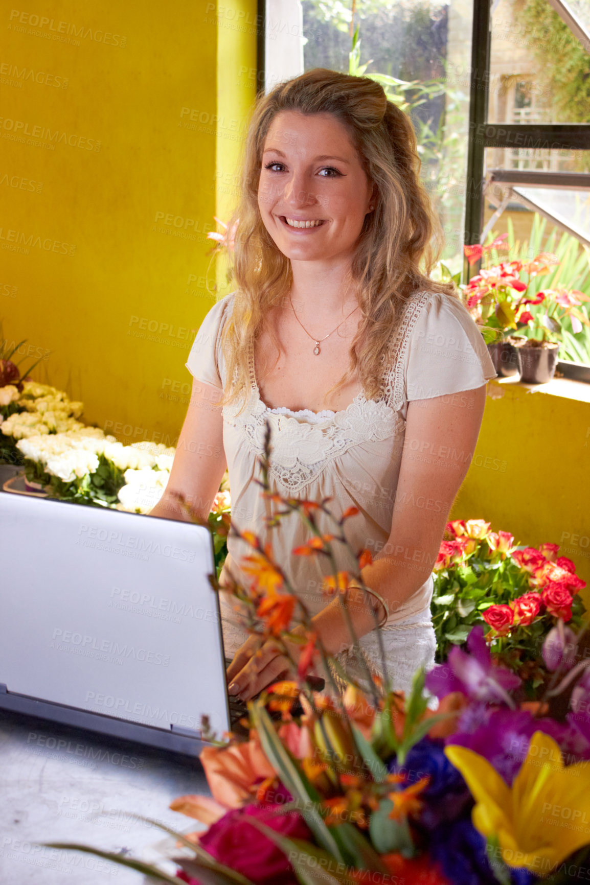 Buy stock photo Shot of a young florist at work in a flower shop