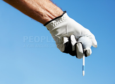Buy stock photo Golf ball, tee and hands of man on blue sky for contest, competition challenge and summer training on mockup. Closeup, gloves and golfer holding pin for action, games and outdoor gear for sports 