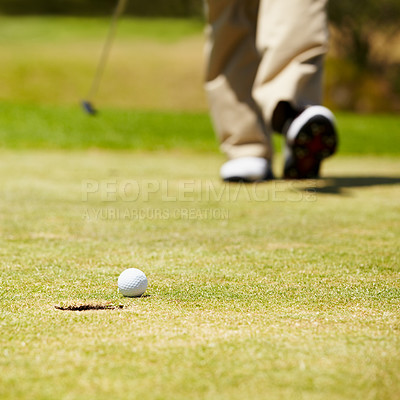 Buy stock photo Golf, ball and hole on a green in summer for sports, recreation or leisure closeup for hobby. Grass, ground or field with a golfer walking on a course during a game of competition or training 